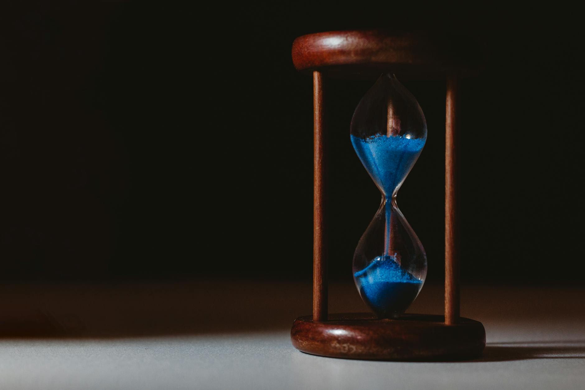 hourglass on brown wooden frame